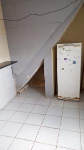 a room with a white floor and a refrigerator at Kitnet recife carnaval 2024 in Recife