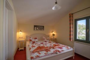 a bedroom with a bed and a window at Villa Stock in Heringsdorf