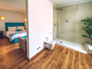 a bathroom with a sink and a bed in a room at Vale da Fonte - Charming Houses in Ponte da Barca