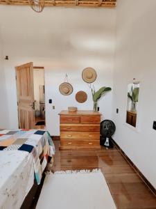 a bedroom with a bed and a wooden dresser at Casa Mar in Caraíva
