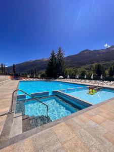 a large swimming pool with blue water at Green Park Village in La Salle