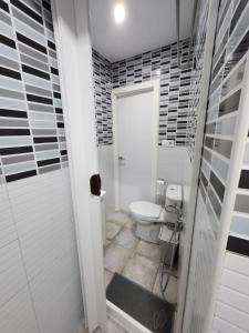 a bathroom with a toilet and a shower at Plan B Madrid Vallecas in Madrid
