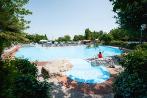 a large swimming pool with people in it at Garden Village San Marino in San Marino