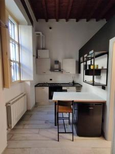 a kitchen with a table in the middle of a room at Casa Volturno in Monza