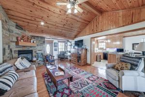 a living room with a couch and a fireplace at Clarksville Home with Porch and Fishing Pond Access! in Clarksville