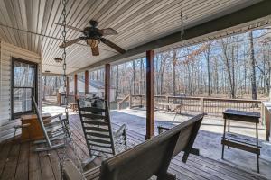 a screened porch with a ceiling fan and a staircase at Clarksville Home with Porch and Fishing Pond Access! in Clarksville