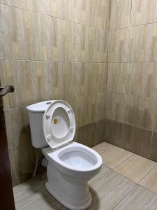 a bathroom with a toilet with the lid up at The pine 2 bedroom house California plaza in Nanyuki