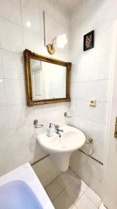 a bathroom with a sink and a mirror and a tub at Center of Prague Apartment 369 in Prague