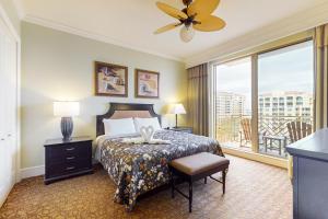 a hotel room with a bed and a balcony at Sandpearl unit 757 in Clearwater Beach