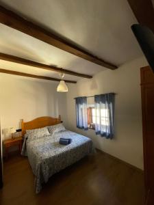 a bedroom with a bed and a window at La magnolia in La Puerta de Segura
