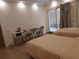a hotel room with two beds and a table with a tv at Fantastic new rooms close to New Cairo Festival City and airport in Cairo