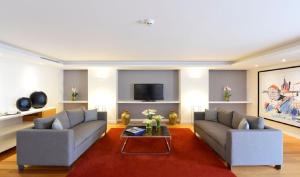 a living room with two couches and a coffee table at Pestana Cidadela Cascais - Pousada & Art District in Cascais