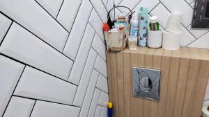 a counter with toiletries on it next to a wall at Room Angel in Petrovaradin