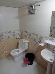 a bathroom with a toilet and a sink at Jarif st. Martin eco resort in Jaliapāra