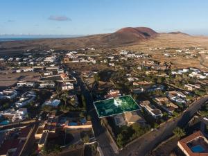 an aerial view of a city with ayers rock in the background at La Milagrosa Surf House & CoWork in Lajares