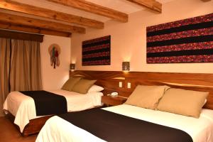 Un ou plusieurs lits dans un hébergement de l'établissement Hotel Mansion Del Valle