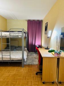 a room with two bunk beds and a desk at DLTA Hote in Torcy