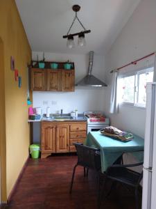 a small kitchen with a table and a stove at La Soñada II in Alta Gracia