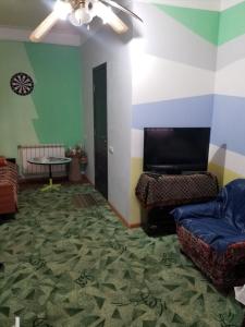 a living room with a couch and a table at Guest House Dompolski in Gyumri