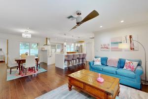 a living room with a blue couch and a table at Pink Flamingo in Naples