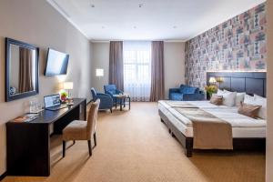 Rúm í herbergi á Taurus Hotel & SPA