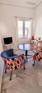 sala de estar con mesa y 2 sillas en Vivienda con fines turísticos "Casa Paquita", en Andújar