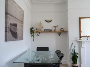 a glass table and chairs in a room at Longsands Beach, Apartment 4, Tynemouth in Tynemouth