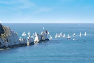 a group of sailboats in the water next to cliffs at 51 oaklands in Cowes
