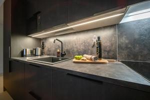 a kitchen counter with a sink and a cutting board at Slopeside Bliss C21 Levi Center by Aavalevi in Levi +27 photos