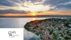 an aerial view of a town on the beach at sunset at Miryana Guest House in Ohrid