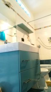 ein Badezimmer mit einem blauen Schrank und einem WC in der Unterkunft Your home in Rome in Rom