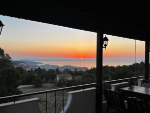 a view of the sunset from a balcony at Philoxenia in Kavála