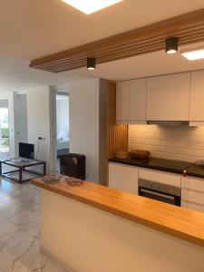 a kitchen with white cabinets and a counter top at Appartamento Long Beach in Punta del Este