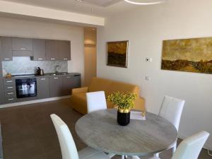 a kitchen and a dining room with a table and chairs at Nuovo Residence Serenissima Frontemare - Agenzia Cocal in Caorle