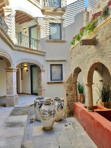 a group of vases sitting outside of a building at Casa 63 Hotel Boutique & Spa in San Miguel de Allende