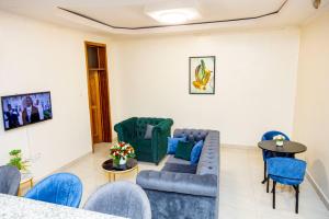 a living room with a couch and chairs at KIGALI GREET HOTEL in Kigali