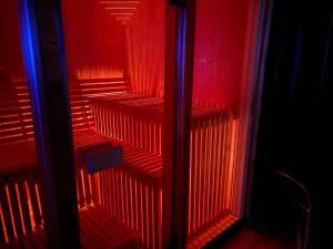 a red and blue staircase in a room at Samsara Domek koło Międzygórza Z sauną i klimatyzacją in Jaworek
