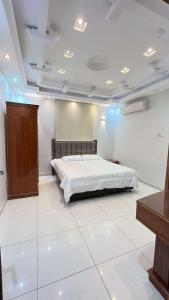a bedroom with a bed in a white room at فيلا توينز in Taif