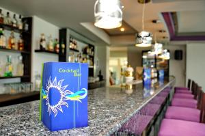 a bar with a cooler on the counter in a store at Akti Dimis Hotel in Tigaki