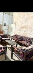a group of beds sitting next to a brick wall at فيلا توينز in Taif