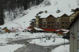 a ski resort in the snow with a ski lift at Cozy updated 3 BDRM/3 BTH on ski hill with private hottub (110) in Kimberley