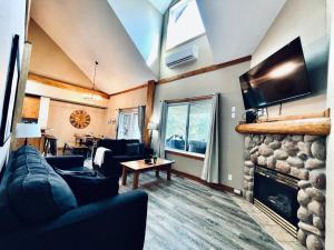 a living room with a couch and a fireplace at Cozy updated 3 BDRM/3 BTH on ski hill with private hottub (110) in Kimberley