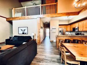 a living room with a couch and a table at Cozy updated 3 BDRM/3 BTH on ski hill with private hottub (110) in Kimberley