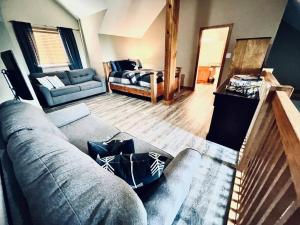 a living room with a couch and a bed at Cozy updated 3 BDRM/3 BTH on ski hill with private hottub (110) in Kimberley