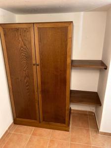 a wooden cabinet in a corner of a room at Casa indipendente Leo Mar in Lampedusa