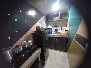 a small kitchen with green lights on the wall at Impeccable 1-Bed Apartment 