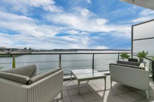 a balcony with a view of the water at AWSA On the Water Luxury (4003) in Auckland