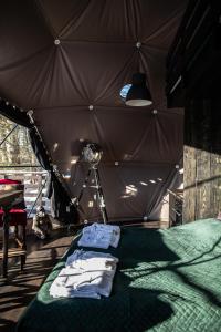 a bedroom with a tent with a bed and a light at BUNNY GLAMP in Korbielów
