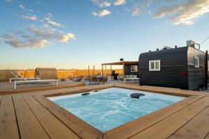 a tiny house with a hot tub on a deck at Remote Home Shroom Room Hot Tub Pool Sauna in Sunfair Heights