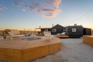 a backyard with a deck and a tiny house at Remote Home Shroom Room Hot Tub Pool Sauna in Sunfair Heights